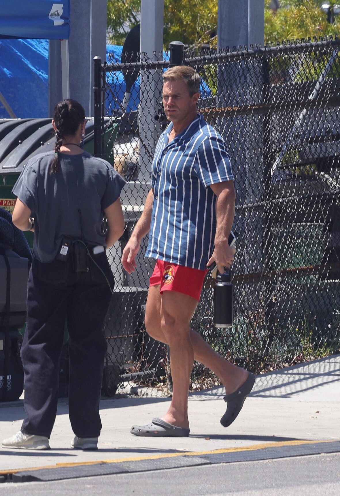 Stephen Amell arrives on BAYWATCH set in iconic red swim trunks and striped shirt