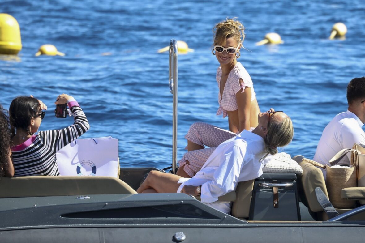 Bella Hadid wears a pink gingham outfit and sunglasses while on a boat in Cannes.