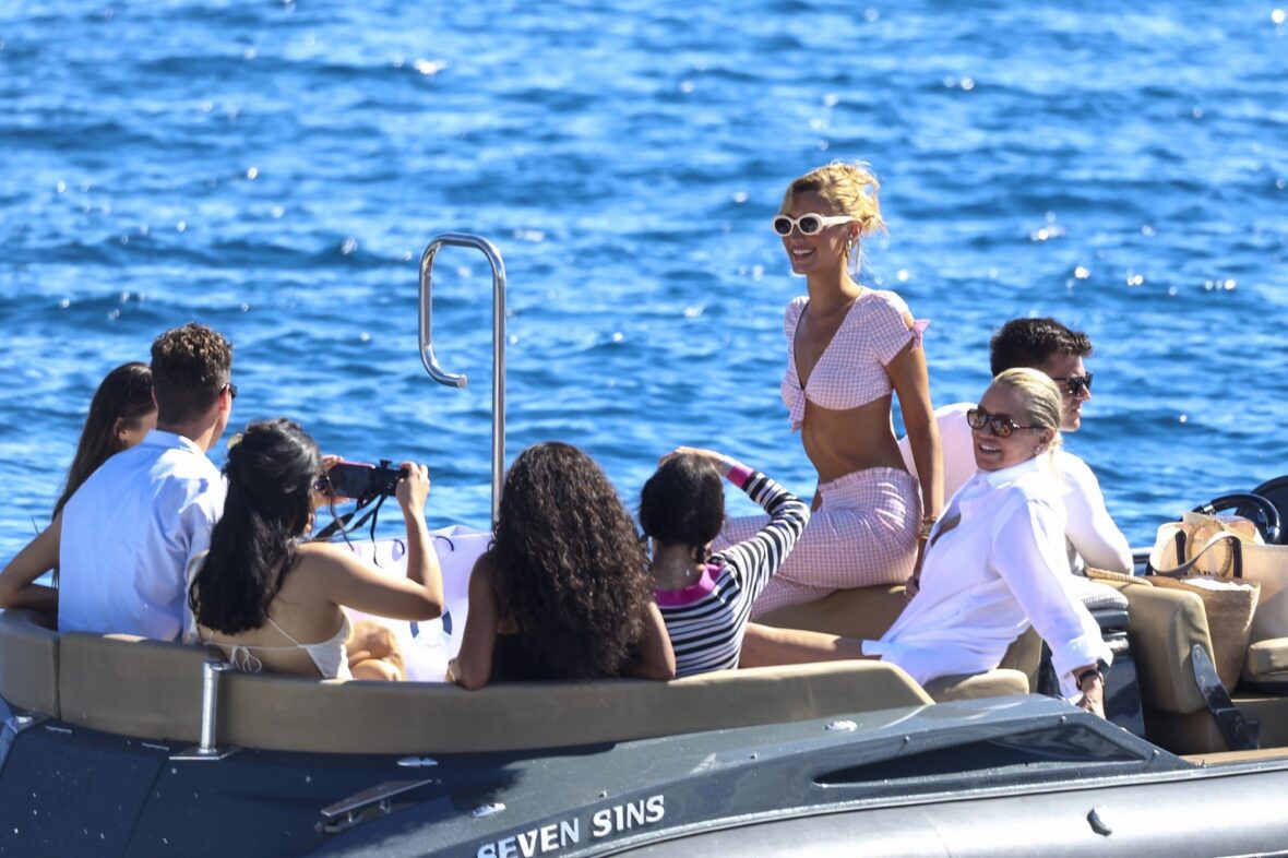 Bella Hadid wears a pink gingham outfit and sunglasses while on a boat in Cannes.