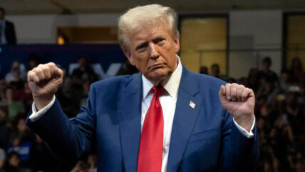 Donald Trump stands onstage in 2024