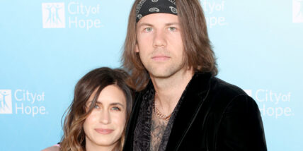 Caleb Shomo and his wife Fleur on the red carpet posing together during a past appearance