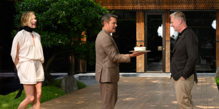 Image from the The Odyssey Beijing Photocall on July 30, 2026 in Beijing, China. Matt Damon presents Christopher Nolan with a cake while Charlize Theron looks on
