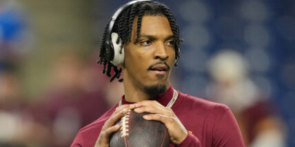 Jayden Daniels warming up for an NFL game stock photo