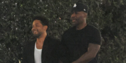 Karamo Brown and Jussie Smollett walk down the street arm in arm together