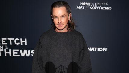 Sid Wilson attends the premiere of "Home Stretch: Starring Matt Mathews" in a dark gray sweater.