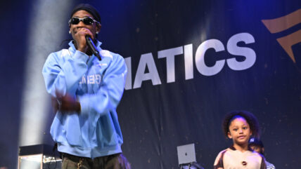 Travis Scott performs on stage at Fanatics Fest with daughter Stormi