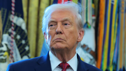 Donald Trump standing in suit