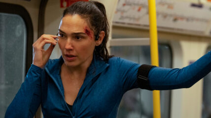 A still of Gal Gadot in a blue tracksuit on a subway in "The Runner."