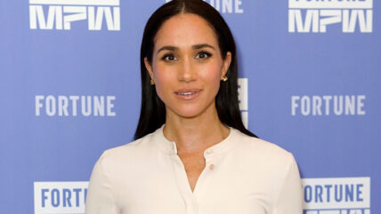 Meghan Markle in white outfit at event.