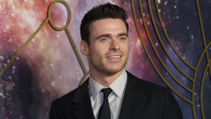 Richard Madden smiles while attending Eternals premiere