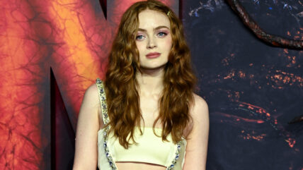 Sadie Sink in a pale yellow dress at a Stranger Things event.