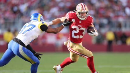 Christian McCaffrey #23 of the San Francisco 49ers runs against Quentin Lake #37 of the Los Angeles Rams