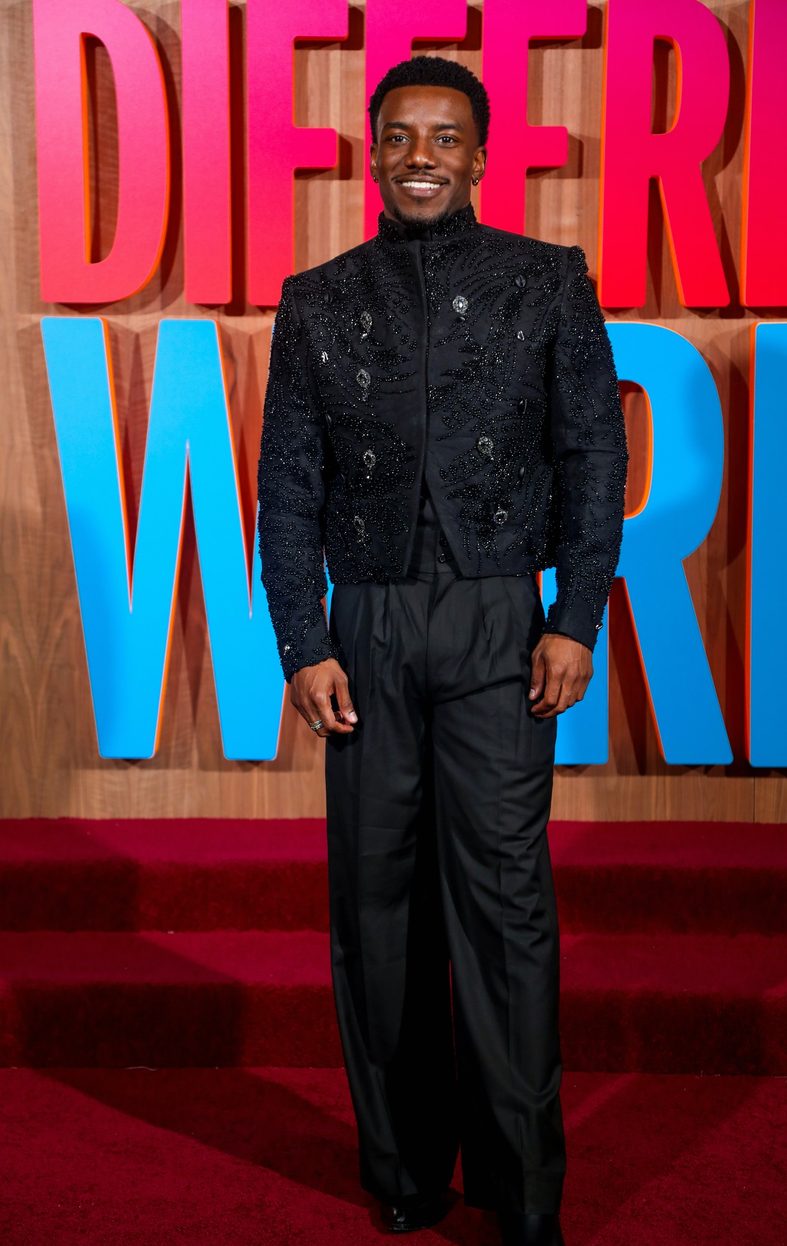 Chibuikem Uche poses on the red carpet at the A Different World premiere