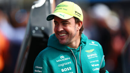 Fernando Alonso smiles at an F1 race