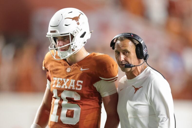  Steve Sarkisian and Arch Manning on the football field during a Texas Longhorns game