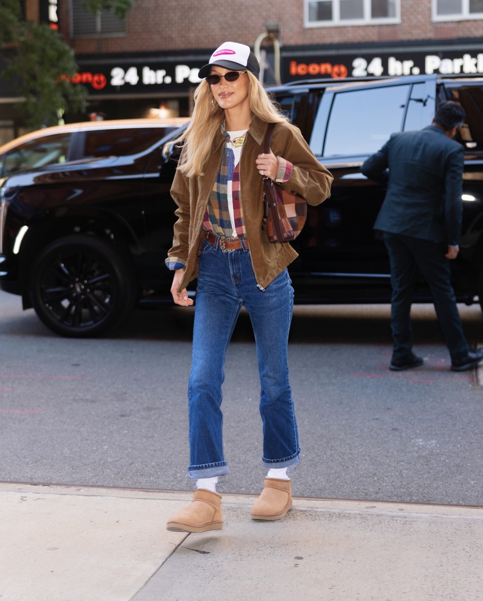 Bella Hadid in a casual, layered look featuring jeans and UGG boots in New York.