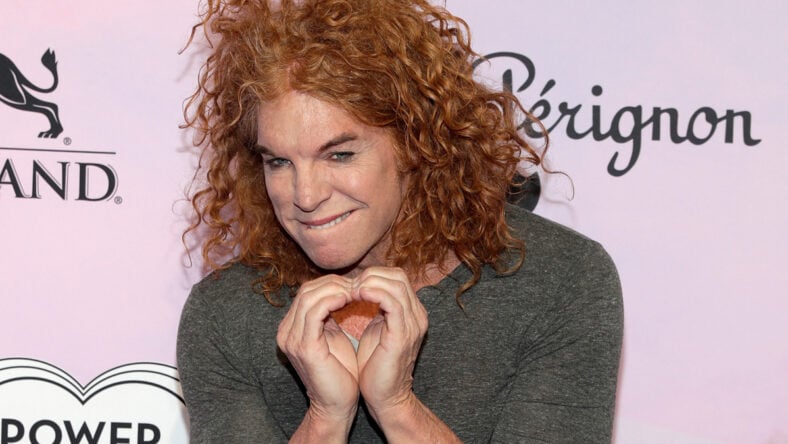 Carrot Top with his fingers pressed together at a charity gala.