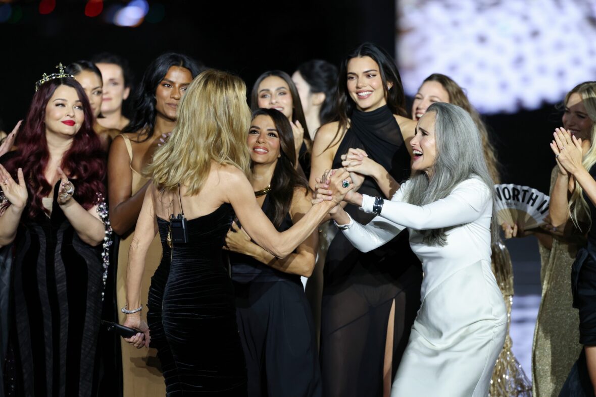 Céline Dion wears a black dress while performing on the runway at the L'Oreal show in Paris.