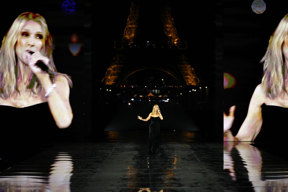 Céline Dion wears a black dress while performing on the runway at the L'Oreal show in Paris.