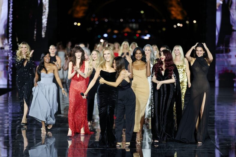 Céline Dion wears a black dress while performing on the runway at the L'Oreal show in Paris.