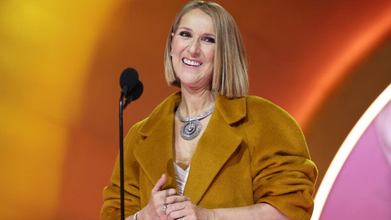 Celine Dion on stage with a microphone.