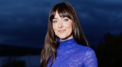 Dakota Johnson smiling in blue