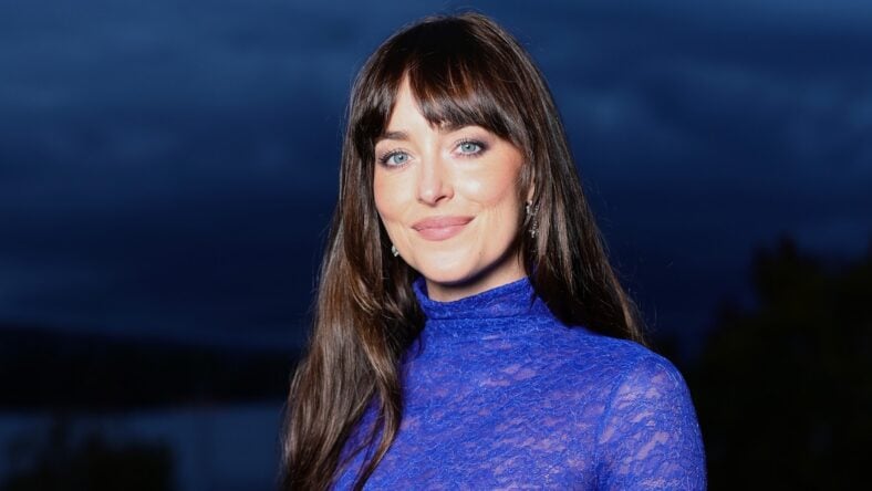 Dakota Johnson smiling in blue