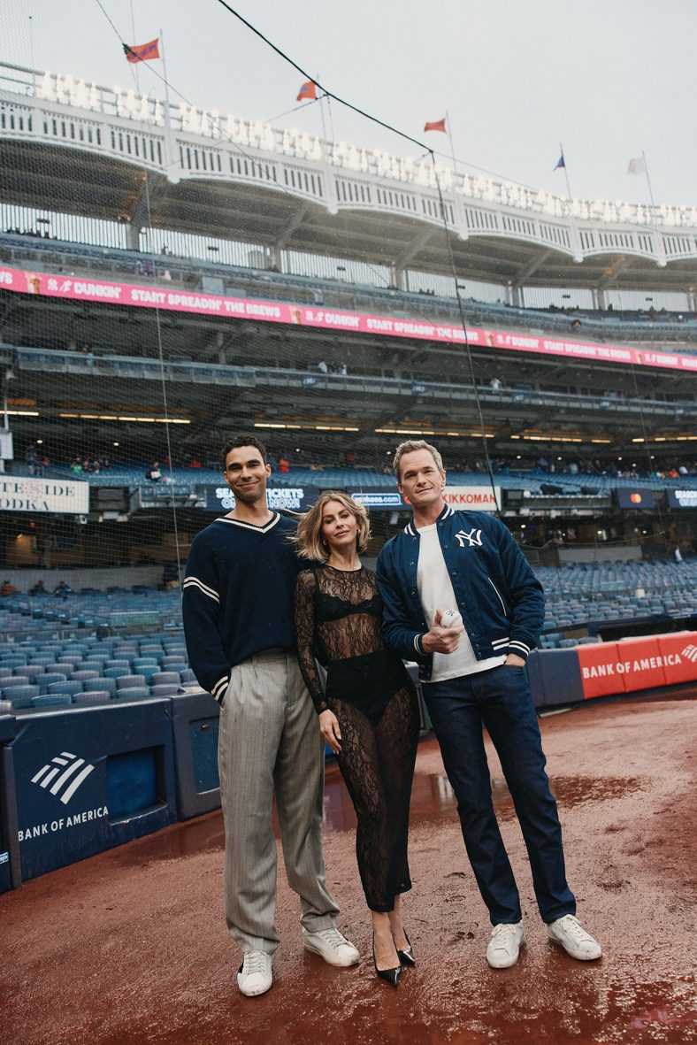 Austin Scott, Julianne Hough and Neil Patrick Harris pose on the field at Yankees Stadium