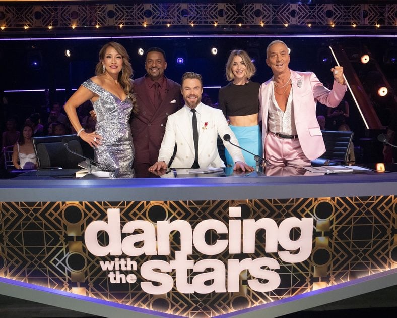 Dancing with the Stars season 35 judges and hosts pose for a group photo at the judges desk