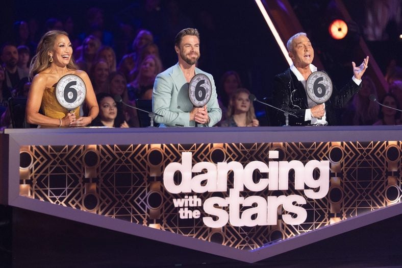 Carrie Anne Inaba, Derek Hough, Bruno Tonioli hold up their scores on Dancing with the Stars