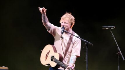 Ed Sheeran performing on stage with guitar