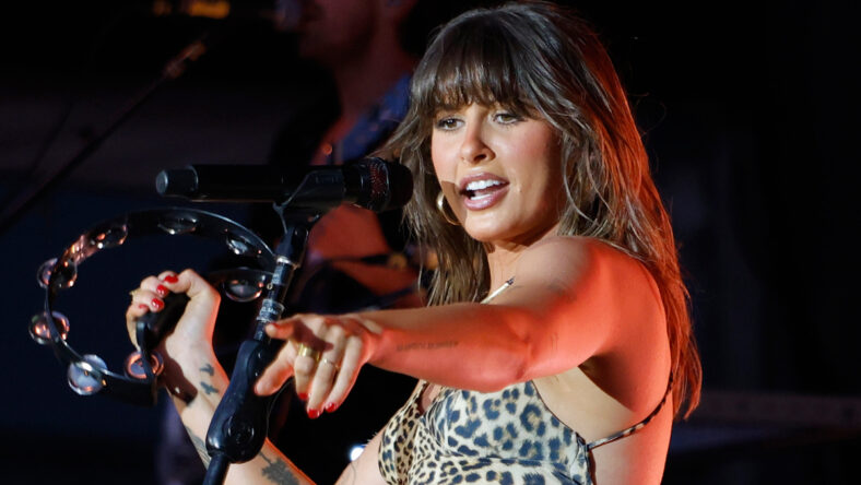 Ella Langley performs on stage in a leopard-print dress