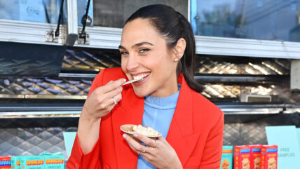 Gal Gadot eats Goodles while wearing a red suit