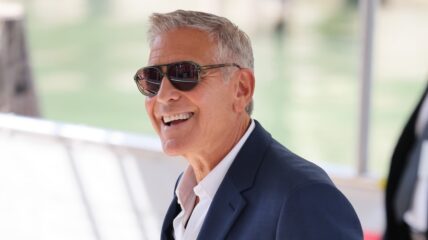 George Clooney at Venice Film Festival smiling in sunglasses