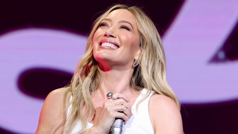 Hilary Duff smiles while on stage during a concert