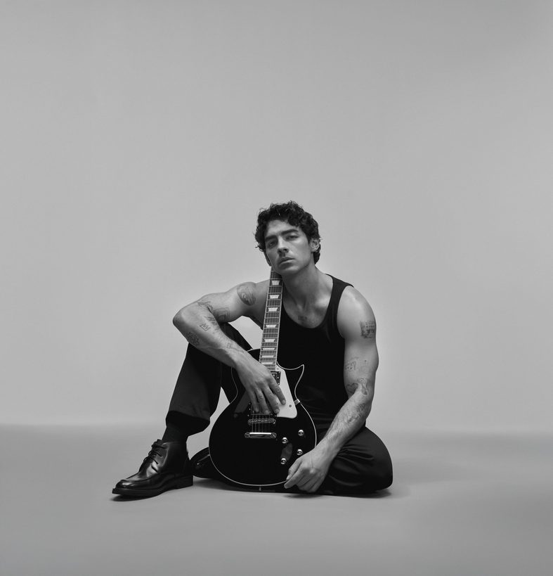 Joe Jonas poses with a guitar for Kenneth Cole's Inspire campaign