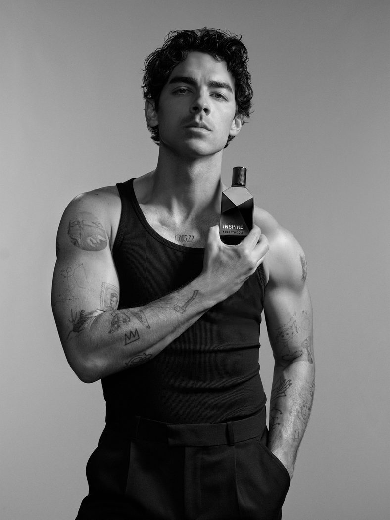 Joe Jonas poses with a fragrance bottle for new Kenneth Cole Inspire campaign