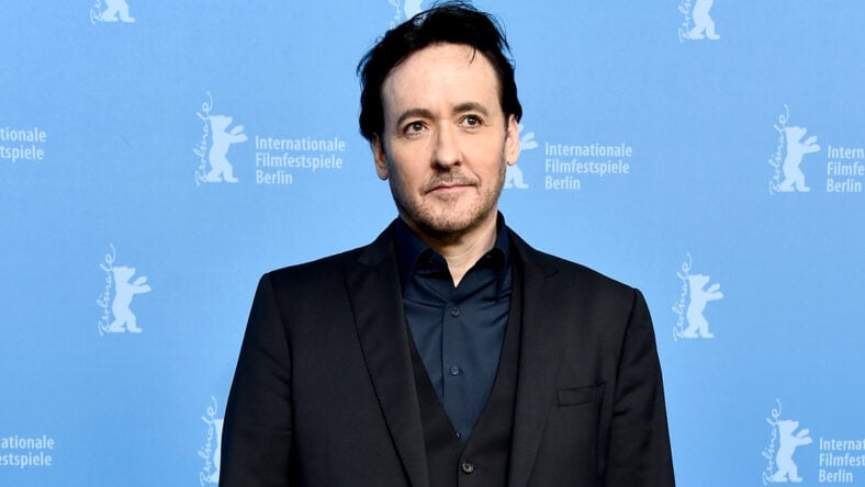 John Cusack in a black suit attends the 'Chi-Raq' photo call.
