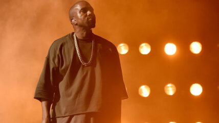 Kanye West performing on stage.