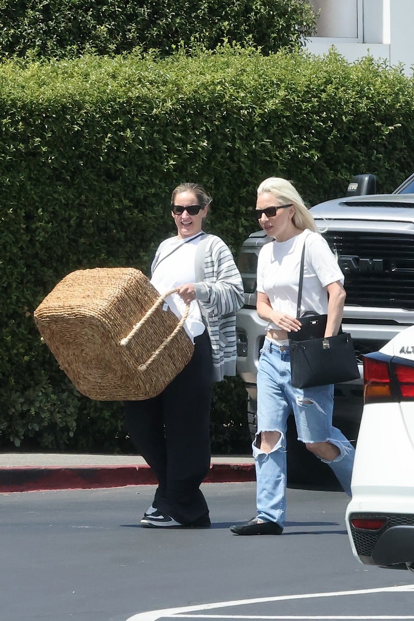 Lady Gaga wears jeans and a T-shirt while walking alongside her assistant.