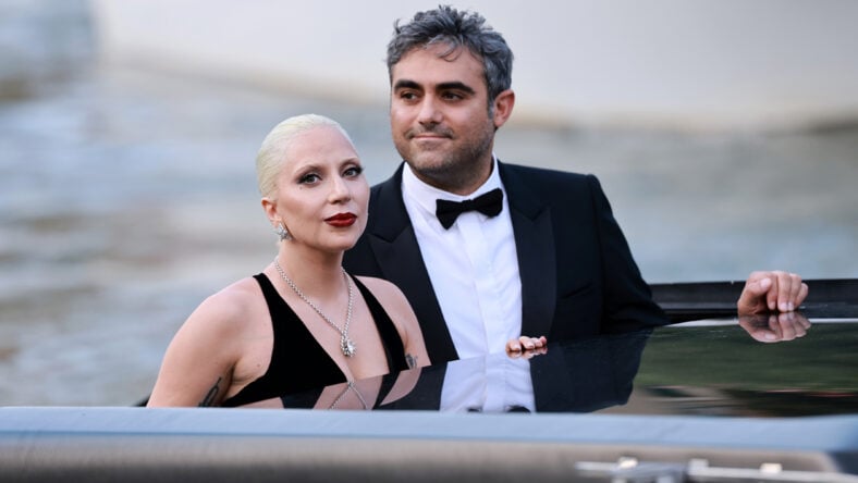 Lady Gaga wears a black dress as she emerges from a vehicle at the Venice Film Festival alongside Michael Polansky.