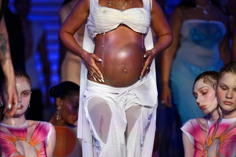 Leigh Anne Pinnock modeling at the Di Petsa show in London, England on September 21. She's wearing a lactating bra and baring her baby bump