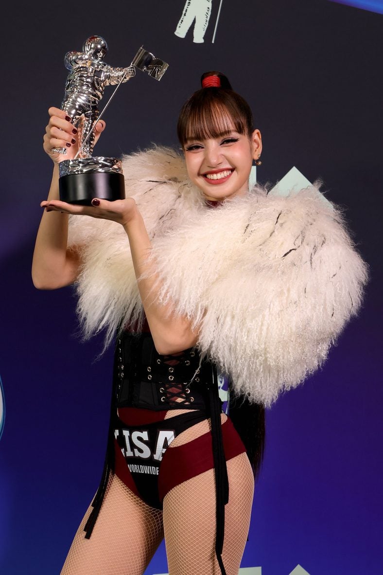LISA poses with her trophy in the press room at the 2026 MTV VMAs