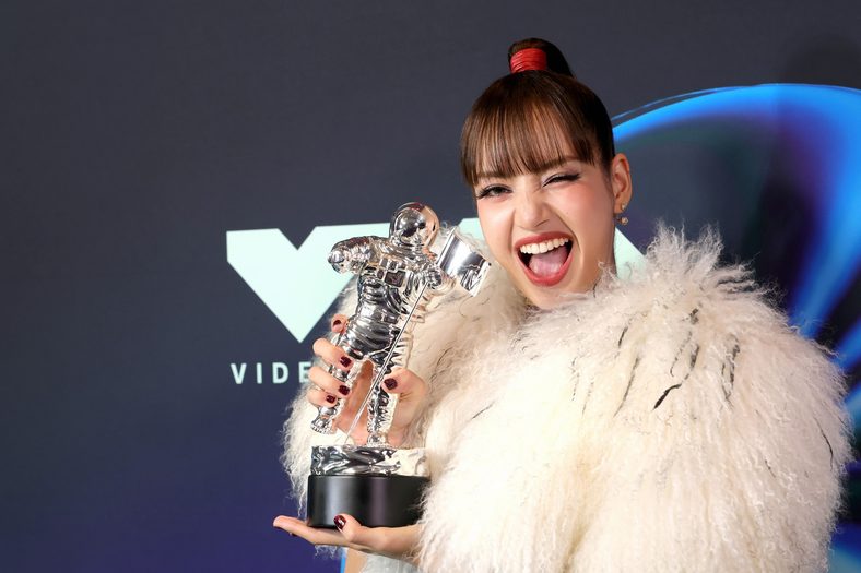 LISA poses with her trophy in the press room at the 2026 MTV VMAs
