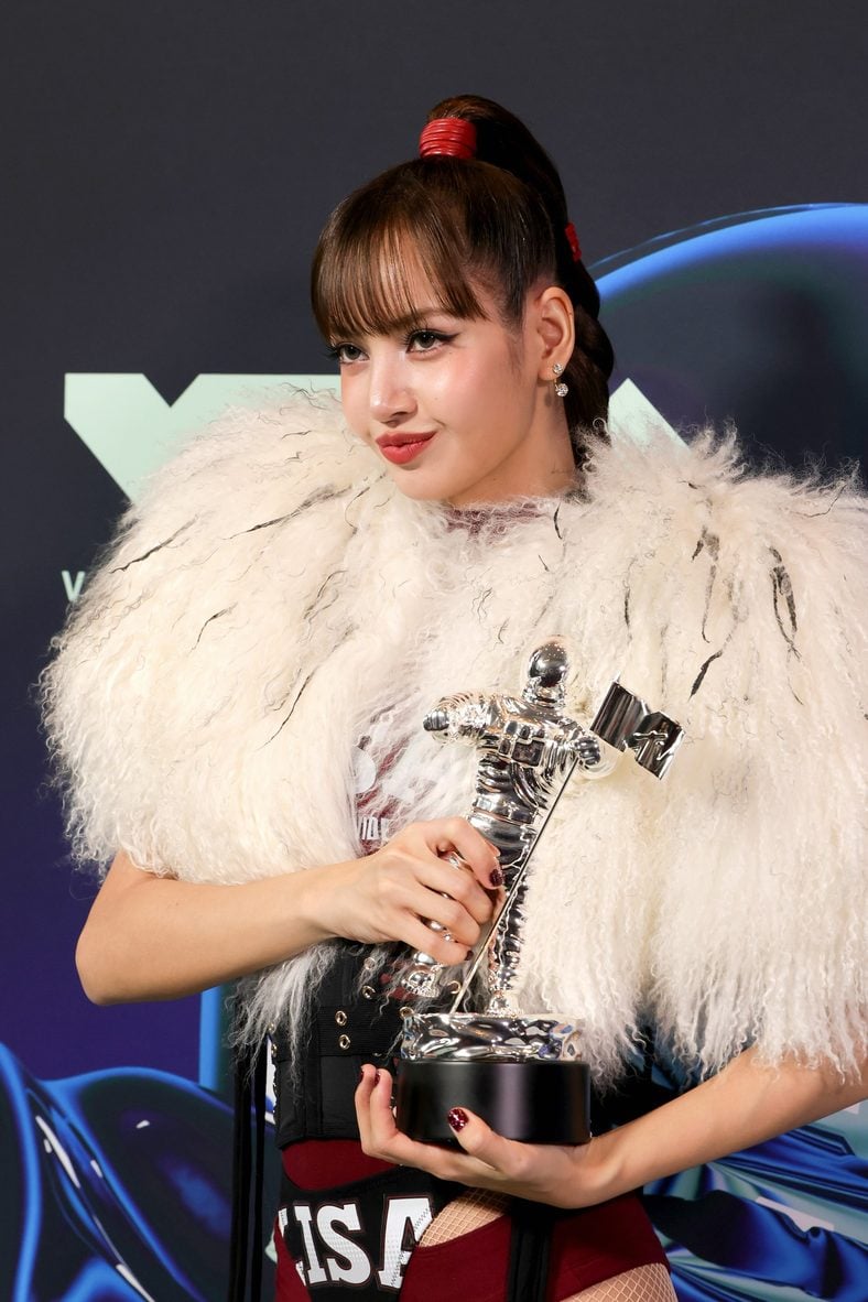 LISA poses with her trophy in the press room at the 2026 MTV VMAs