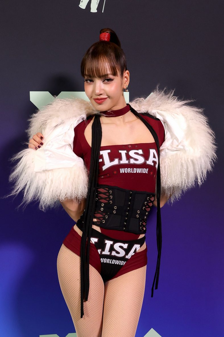 LISA poses with her trophy in the press room at the 2026 MTV VMAs