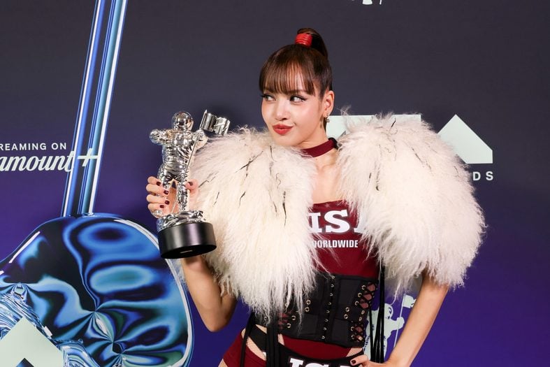 LISA poses with her trophy in the press room at the 2026 MTV VMAs