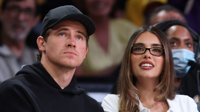 Madison Beer & Justin Herbert stock image from an NBA game