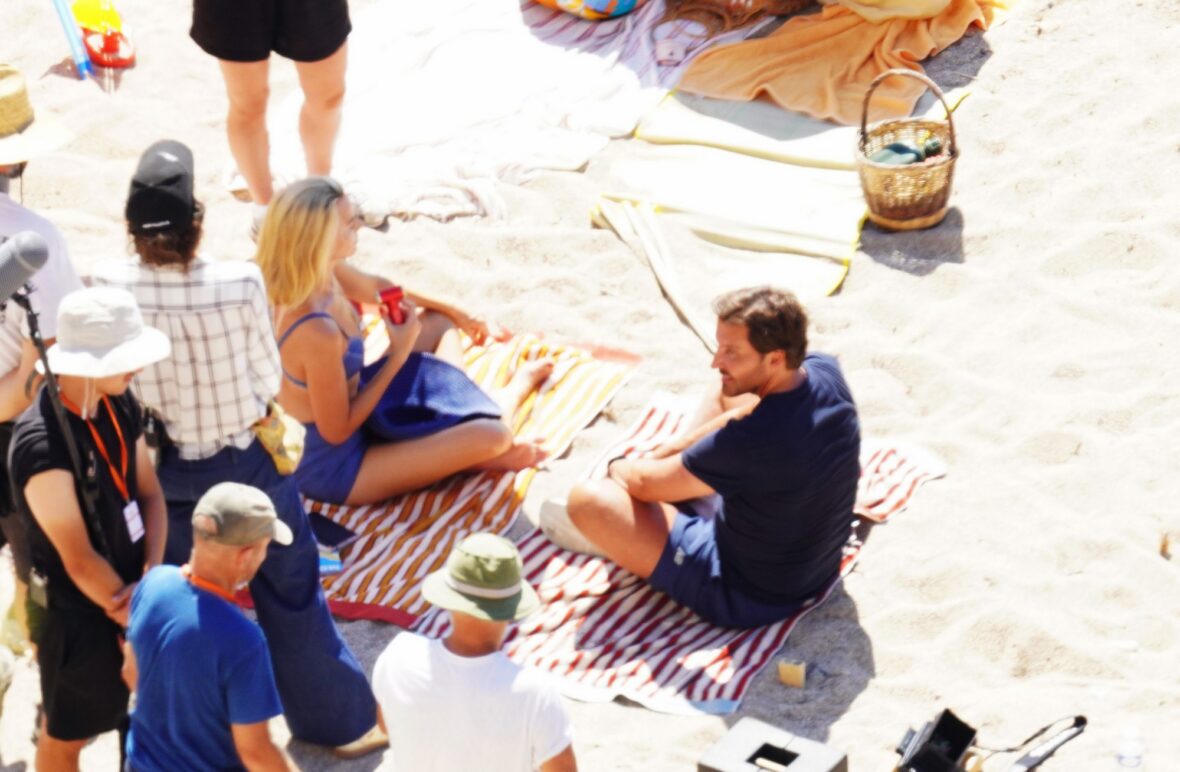 Margot Robbie and Bradley Cooper in swimsuits on beach for Ocean's Eleven prequel movie