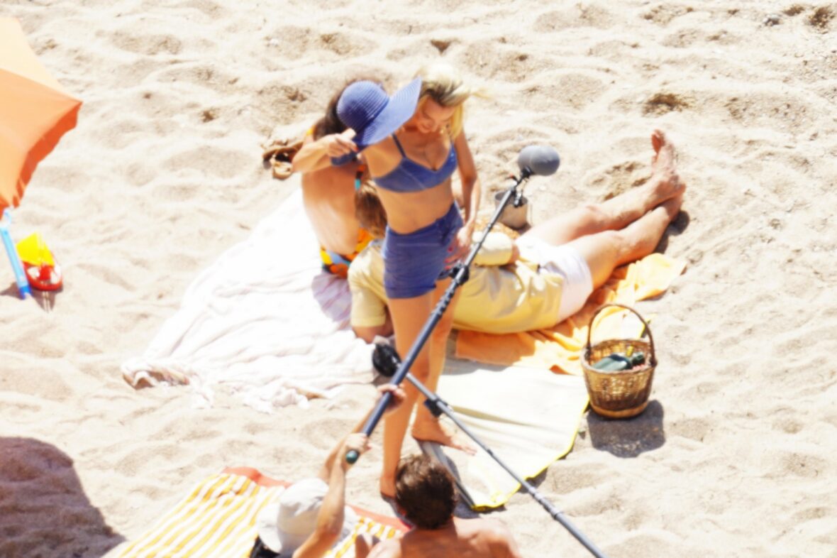 Margot Robbie and Bradley Cooper in swimsuits on beach for Ocean's Eleven prequel movie